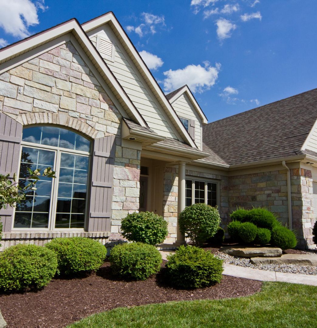 suburban brick home and well kept landscaping